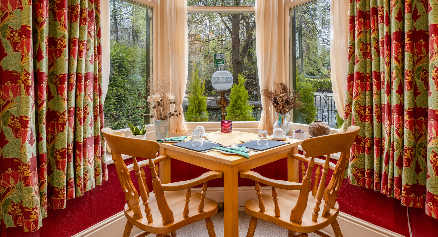Breakfast table set for two in the bay window