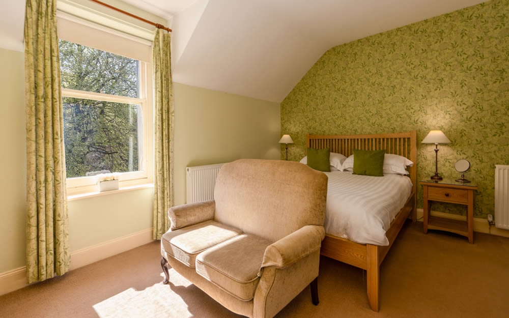 Room 4, large king room with Jasmine green wallpaper and Queen Anne chair